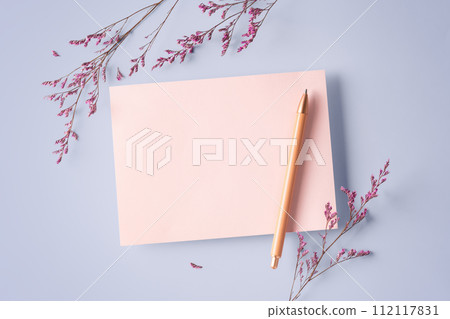 Pink card with pen and pink flower on pastel purple background, top view Pink card with pen and pink flower on pastel purple background, top view 112117831