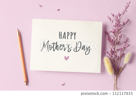 Mother's day card with pen and flower on pink background, flatlay 112117833