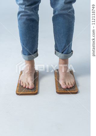 Sadhu board, yoga board with nails, guy stands on the board with nails, yoga concept Sadhu board, yoga board with nails, guy stands on the board with nails, yoga concept 112118749