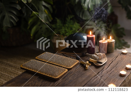 Sadhu board, yoga board with nails, guy stands on the board with nails, yoga concept 112118823