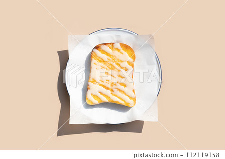 Grilled butter tosat with condensed milk on white plate Grilled butter tosat with condensed milk on white plate 112119158