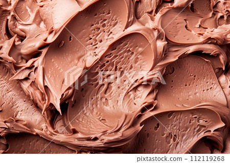 A closeup view of a generous swirl of chocolate whipped cream or smooth chocolate cream as background 112119268