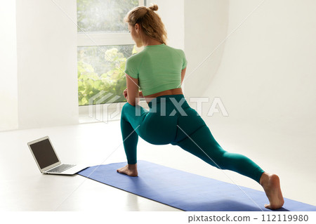 girl doing morning exercises and stretching online on a white background, online fitness training girl doing morning exercises and stretching online on a white background, online fitness training 112119980