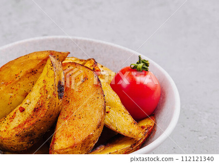 Roasted potato wedges with spices Roasted potato wedges with spices 112121340