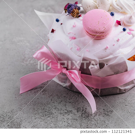 Easter cake decorated with meringues and macarons 112121341