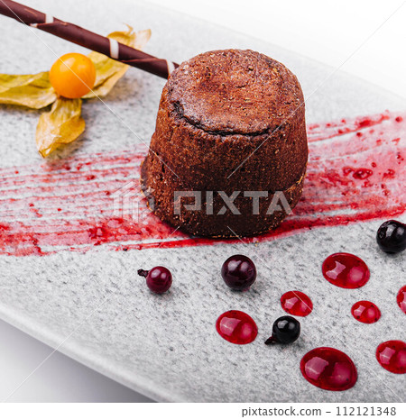 White plate with chocolate fondant cake 112121348