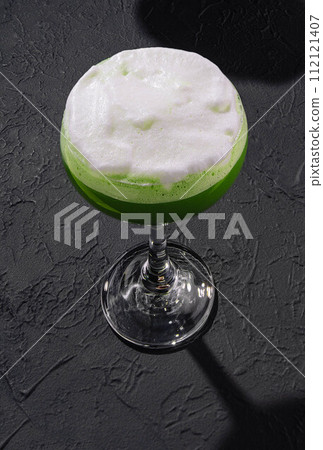 Green alcoholic cocktail for women with foam Green alcoholic cocktail for women with foam 112121407