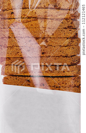 close up of white sliced toast bread in transparent packaging 112121465
