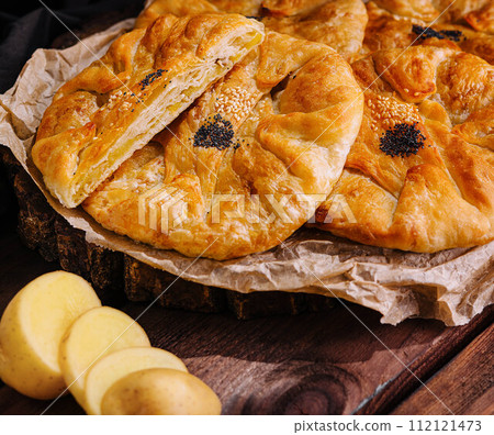 Cooking traditional pies with potato on wooden board Cooking traditional pies with potato on wooden board 112121473