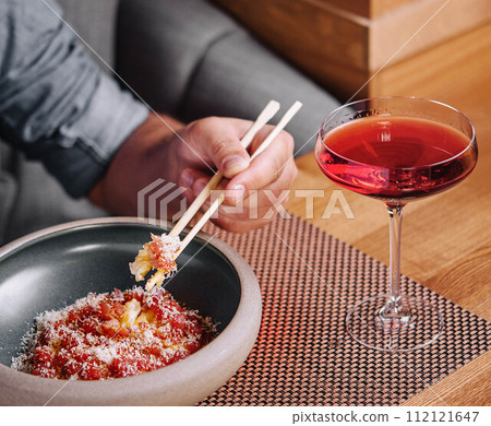 Man Eating Salmon Tartare with Parmesan Cheese Man Eating Salmon Tartare with Parmesan Cheese 112121647