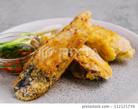 close up fried fish fillet with vegetables close up fried fish fillet with vegetables 112121739