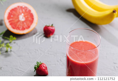 Fresh grapefruit juice in a glass Fresh grapefruit juice in a glass 112121752