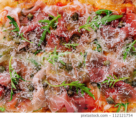 square pizza with prosciutto and arugula square pizza with prosciutto and arugula 112121754