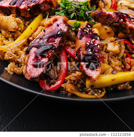 Chinese fried rice with beef on black plate 112121856