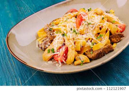 Fettuccine pasta with beef, chicken and parmesan 112121907