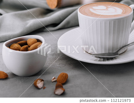 Raf coffee in cup and almonds in bowl Raf coffee in cup and almonds in bowl 112121973