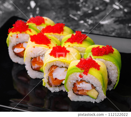 sushi rolls wrapped with avocado and shrimp inside 112122022
