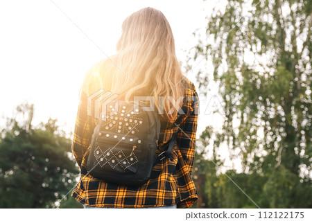 Backpack woman. Hipster girl with backpack in woods. Traveler ba 112122175