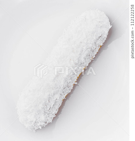 eclair in white glaze and coconut flakes eclair in white glaze and coconut flakes 112122258