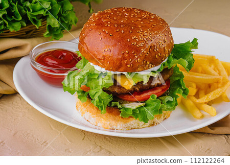 burgers with french fries served on plates burgers with french fries served on plates 112122264