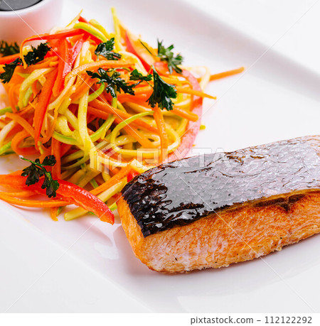 grilled salmon fillet steak with vegetable salad 112122292