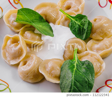 dumplings with basil and cream closeup 112122341
