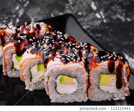 canada sushi rolls with avocado inside and teriyaki sauce canada sushi rolls with avocado inside and teriyaki sauce 112122441