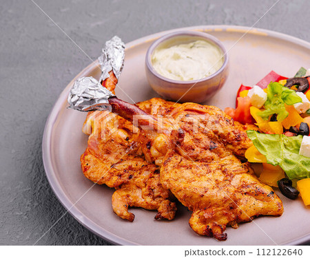 baked golden chicken drumsticks and Greek salad baked golden chicken drumsticks and Greek salad 112122640