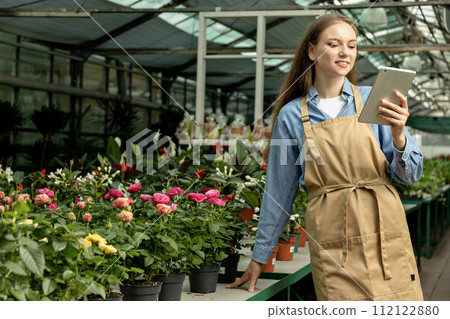 The girl is a green house worker. 112122880
