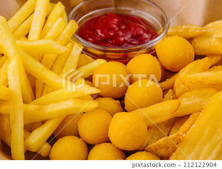 Different types of fried potatoes, such as french fries, roast potatoes and potato balls 112122904