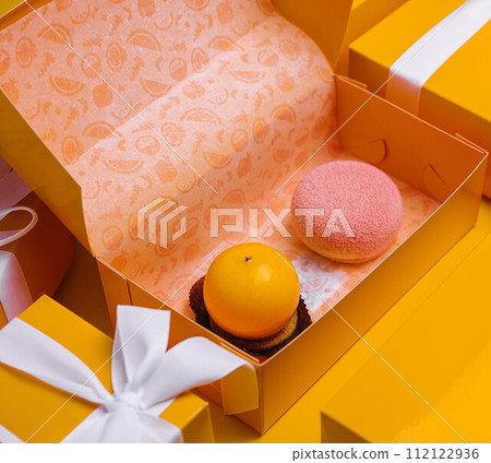 Christmas gifts presents with different cakes on yellow background 112122936