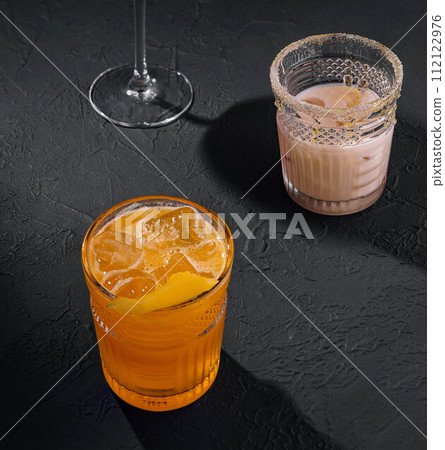Glasses of cold infused water with fresh orange and iced coffee Glasses of cold infused water with fresh orange and iced coffee 112122976