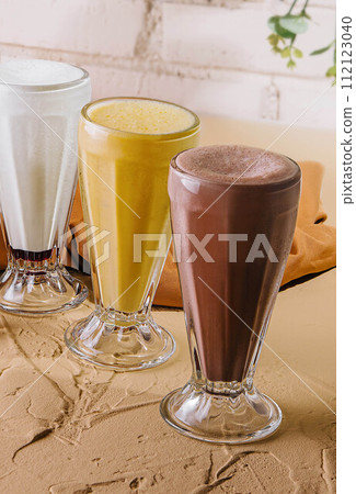 milkshake glasses featuring different flavors 112123040