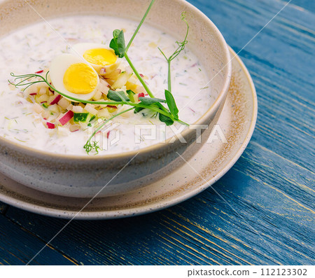 Summer light cold yogurt soup on wooden board Summer light cold yogurt soup on wooden board 112123302