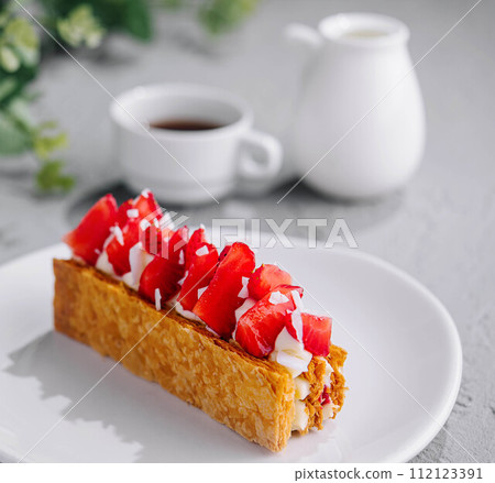 Sweet cake with strawberries on plate Sweet cake with strawberries on plate 112123391
