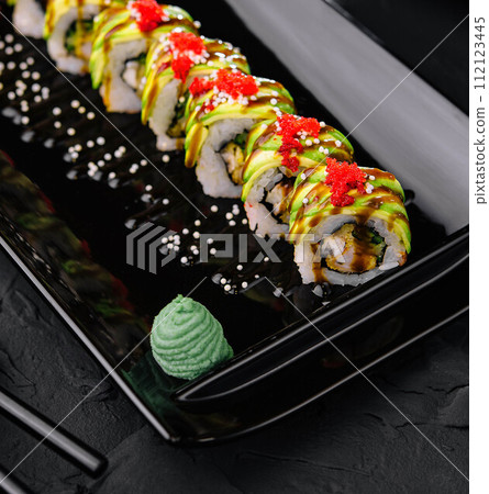 Avocado Sushi roll japanese food on black plate 112123445