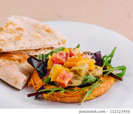 Healthy roasted red pepper hummus and pita bread Healthy roasted red pepper hummus and pita bread 112123450
