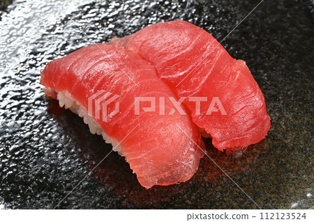 2 pieces of lean tuna nigiri sushi on black background 2 pieces of lean tuna nigiri sushi on black background 112123524