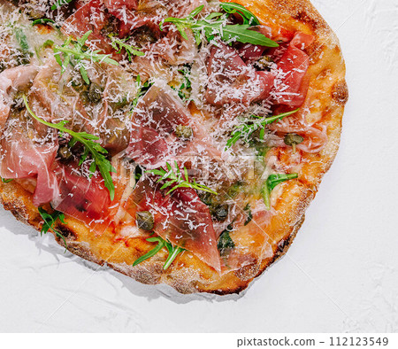 square pizza with prosciutto and arugula 112123549