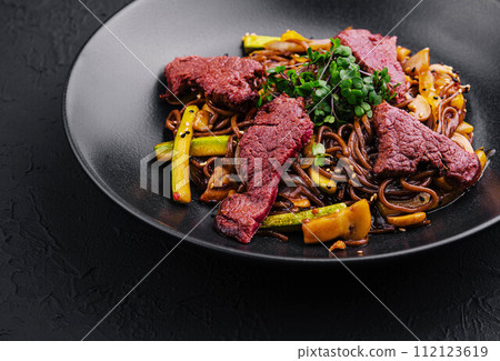 Chinese fried rice with beef on black plate Chinese fried rice with beef on black plate 112123619