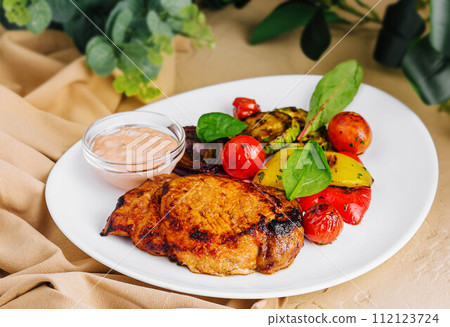 pork ribs with potatoes and pork steak with grilled vegetables pork ribs with potatoes and pork steak with grilled vegetables 112123724