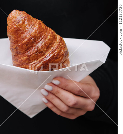 girl holding croissants close up girl holding croissants close up 112123726