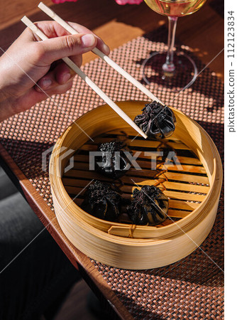asian dumplings with cuttlefish ink top view 112123834