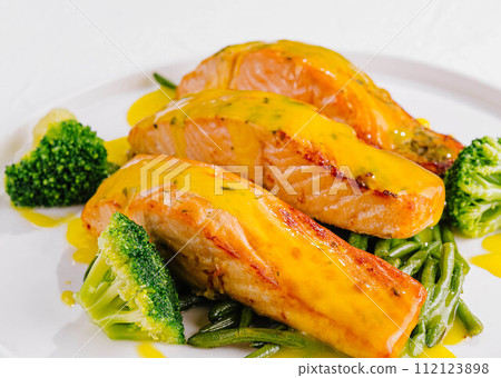 Grilled salmon with asparagus and broccoli Grilled salmon with asparagus and broccoli 112123898