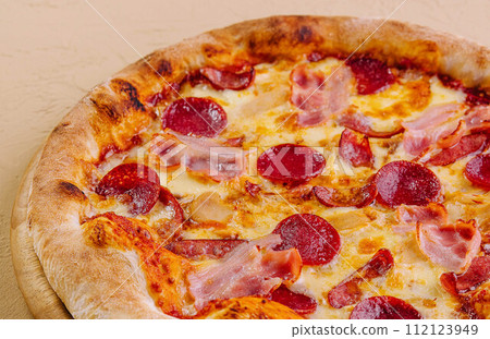 pepperoni pizza with ham on wood pepperoni pizza with ham on wood 112123949