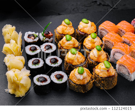 Sushi set on black slate top view 112124015