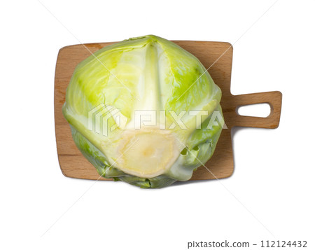 White cabbage on a cutting board on a white background. From the garden. Vegetable isolate. Whole cabbage. Healthy lunch ingredient. Healthy food concept. Can be eaten raw White cabbage on a cutting board on a white background. From the garden. Vegetable isolate. Whole cabbage. Healthy lunch ingredient. Healthy food concept. Can be eaten raw 112124432