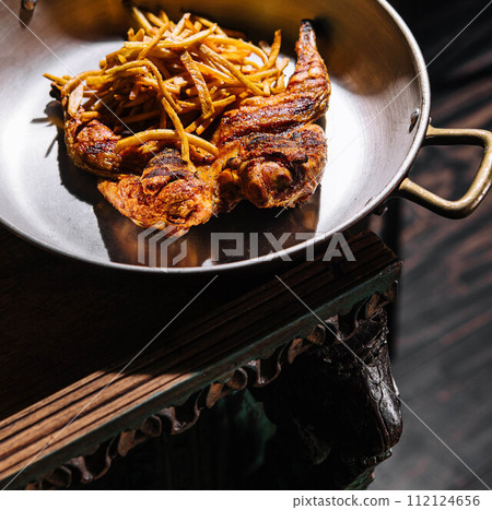 Fried chicken leg with french fries on pan 112124656