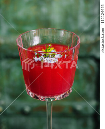 Italian cocktail with flower on gray stone Italian cocktail with flower on gray stone 112124663