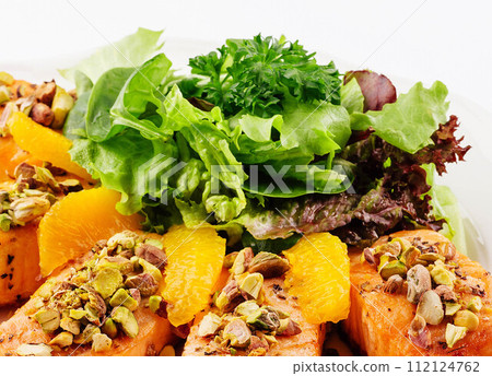 salmon with pistachios, orange slices and lettuce salmon with pistachios, orange slices and lettuce 112124762